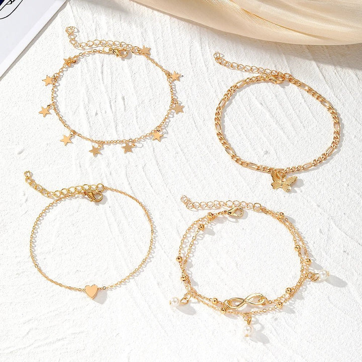 Skanto | 5-teiliges zartes feminines Fußkettchen-Set (Sterne, Herz, Schmetterling, Unendlichkeit, Perlen)