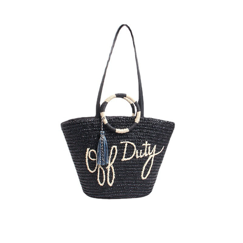 Designer Strohtasche mit verspieltem Text und dekorativem Pompon Skanto